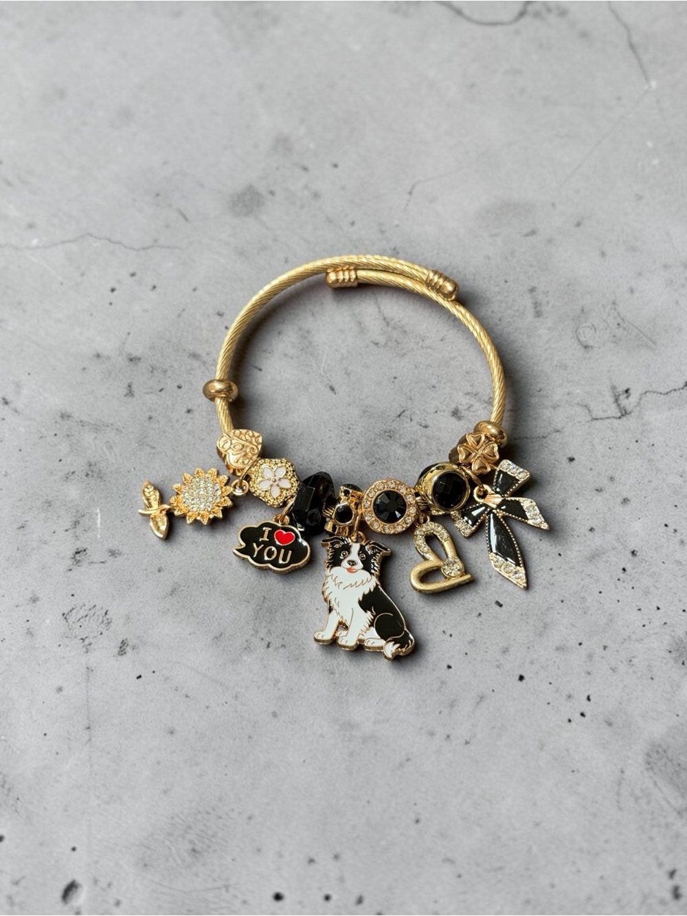 Gold Tone Charm Adjustable Twisted Bangle W/Black & White Dog and Heart Charms